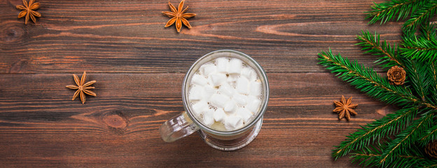 Cocoa with marshmallows on the wooden background