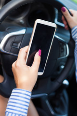 Female driver using smart phone in car .