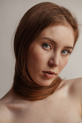 Woman with long thick straight hair on white background in profile