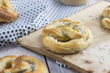 Detail on a Pretzel with salt and poppy seeds on a wooden board