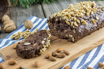 Detail on Christmas Walnut ginger bread on wooden board with almonds
