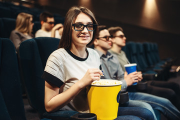 Woman in 3d glasses sitting on seat in cinema