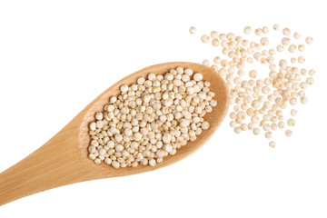 red quinoa seeds in wooden spoon isolated on white background. Top view