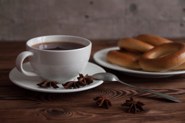 White cup of black tea or coffee on vintage wooden table