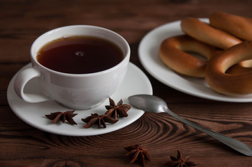 White cup of black tea or coffee on vintage wooden table