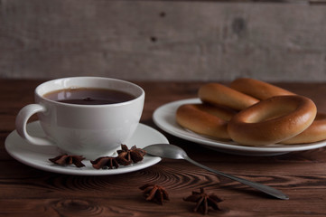 White cup of black tea or coffee on vintage wooden table