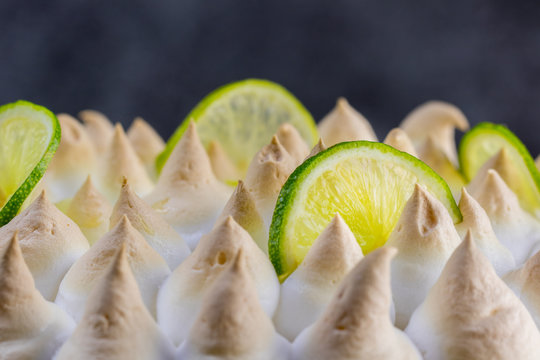 Lime meringue cake with slices of lime - detail view