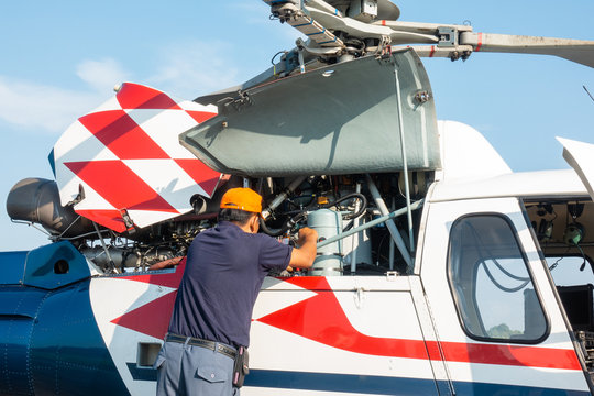 Engineer maintaining a helicopter Engine