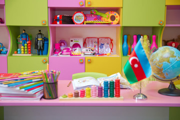 Flag of Azerbaijan for a small table . Kindergarten background . Baku , Azerbaijan . Blurred view of empty playroom