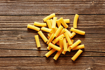 Yellow italian pasta on a wood rustic background