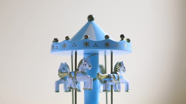 children's toy with spinning wooden horses on the carousel
