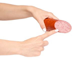 A smoked sausage in hand on a white background isolation