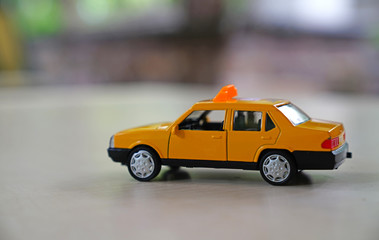 Yellow old taxi car on road on blurred background