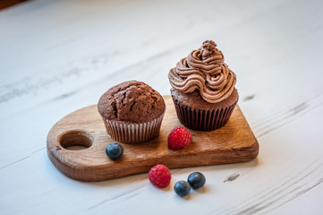 Tasty cupcakes on a white wooden table. Homemade cupcake. Copy space. Soft focus.
