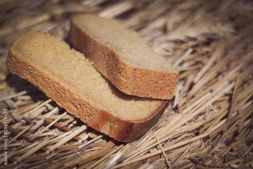 Wall mural two pieces of black bread. the bread lies on the grown bread. the depth of focus is very small.