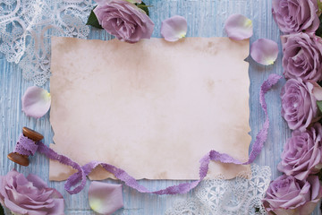 Purple roses on a colored background and paper for text congratulations, invitations