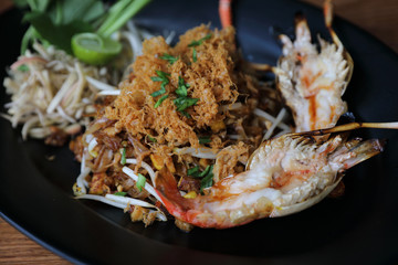 Shrimp pad thai noodles with shrimps on top , Thai food