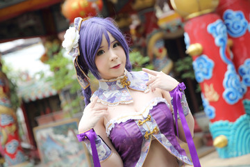 Fototapeta premium Portrait of asian young woman with purple Chinese dress cosplay with temple