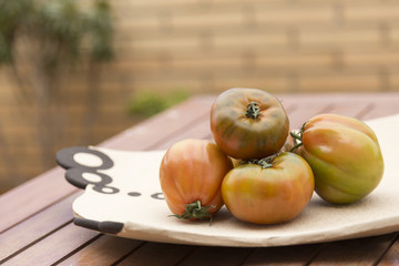 tomatoes on a plate on the table