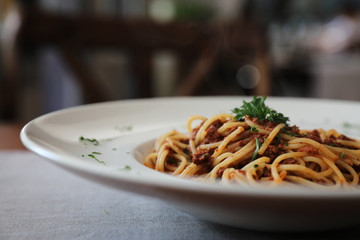 Spaghetti bolognese with beef tometo sauce on wood table , italian food