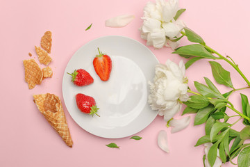 Flatlay on a pink background with white peonies and white plate. Top view. Copy space