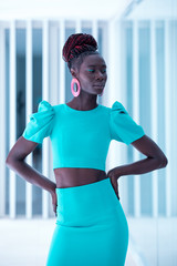 beautiful and attractive black model woman wearing a blue turquoise dress with a fashion makeup...