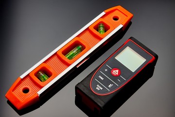 Optical level, laser range finder and a pencil lying on the floor