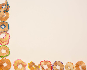 Color pencils shavings on white background