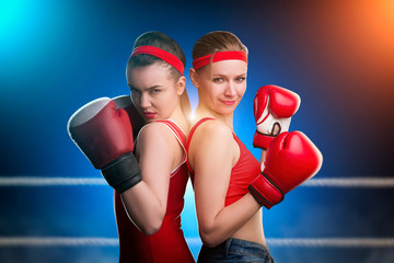 Two female boxers standing back to back