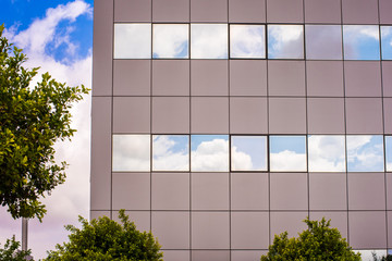 Building windows with sky and clouds reflected