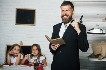 Education in knowledge day. education at school for little girl with bearded teacher holding book.