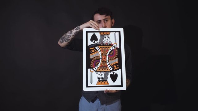 Man showing tricks with cards. Magic, performance, circus, gambling, casino. Show concept - magician showing trick with playing cards.