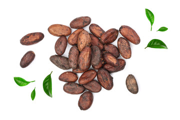 unpeeled cocoa bean decorated with green leaves isolated on white background close-up top view