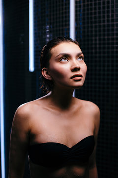 close up photo. asian girl is afraid of taking a shower in the shower cabinet because of claustrofobia