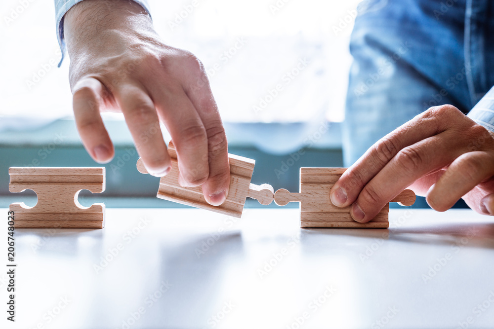 Poster the man points to the same two incompatible jigsaw puzzles. the concept of misunderstanding, non-con