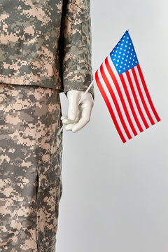 Mannequin in army uniform with usa flag. Patriotic soldier concept. White isolated background.