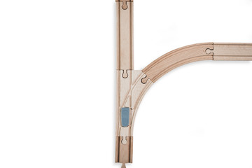 Top view of isolated wooden tracks with a crossover on a white background. The concept of making difficult decisions, changes in life. Time for changes. It will face a dilemma.