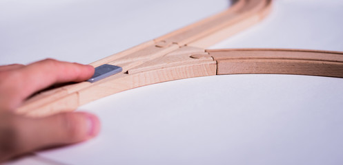 Isolated wooden tracks with a crossover on a white background. The concept of making difficult decisions, changes in life. Time for changes. It will face a dilemma.