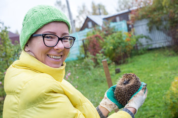 Hedgehog in the hands of a woman