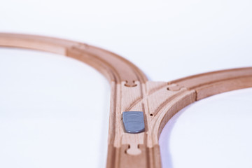 Top view of isolated wooden tracks with a crossover on a white background. The concept of making difficult decisions, changes in life. Time for changes. It will face a dilemma.