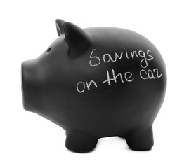 Black piggy bank with words SAVINGS ON THE CAR on white background