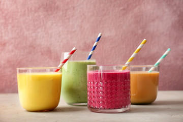Glasses with delicious detox smoothies on table