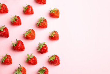 Flat lay composition with with tasty ripe strawberries on color background