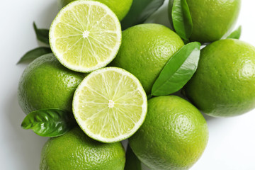 Fresh ripe limes on white background, top view