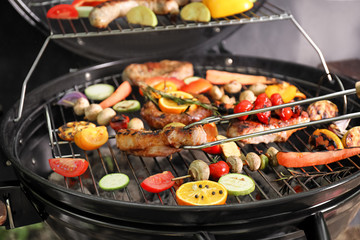 Cooking delicious meat and vegetables on barbecue grill, closeup