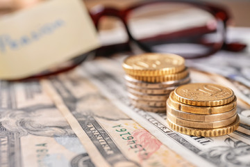 Coins on banknotes, closeup. Pension planning