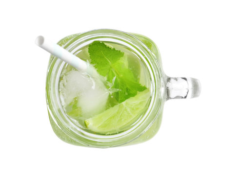 Refreshing beverage with mint and lime in mason jar on white background, top view