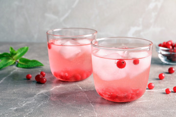 Refreshing natural lemonade in glasses on table