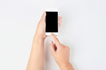 Fototapeta na wymiar Young woman holding mobile phone with blank screen in hand on white background