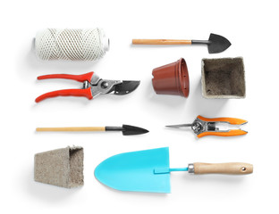 Flat lay composition with professional gardening tools on white background